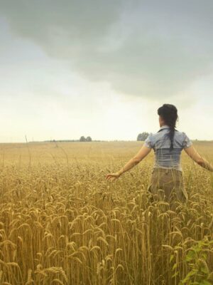 Woman Standing on Rice Field during Cloudy Day